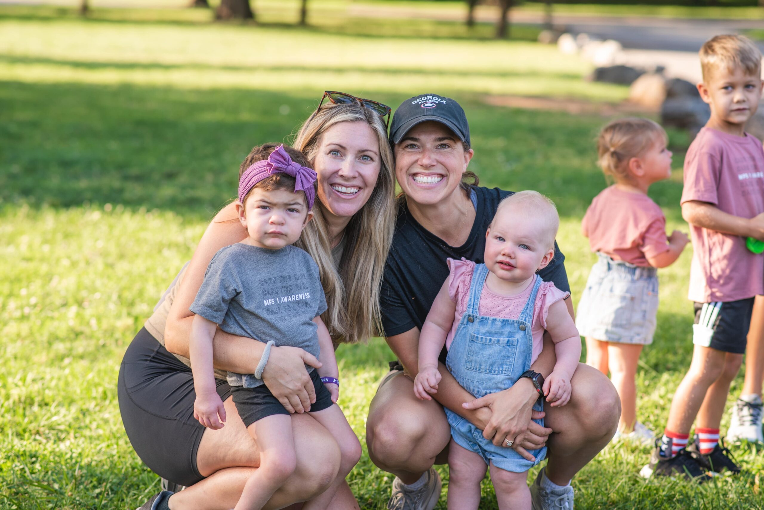 Family with two children poses on the lawn at the MPS 5k