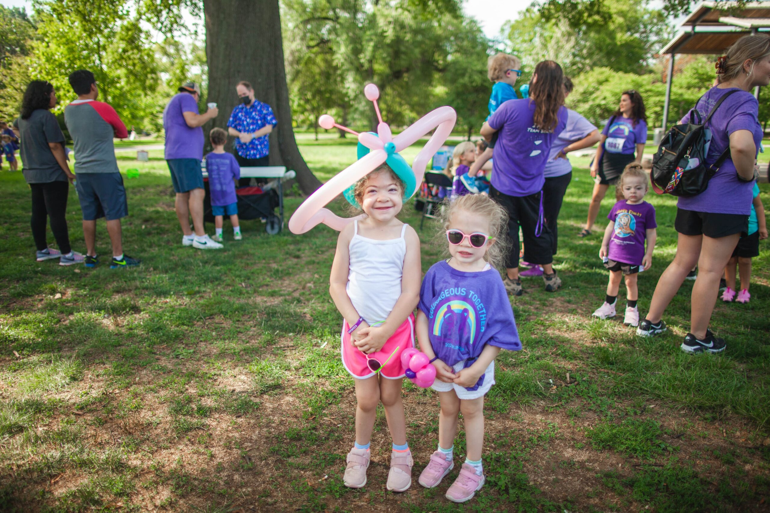 Little girls with balloon animals at a MPS awareness event
