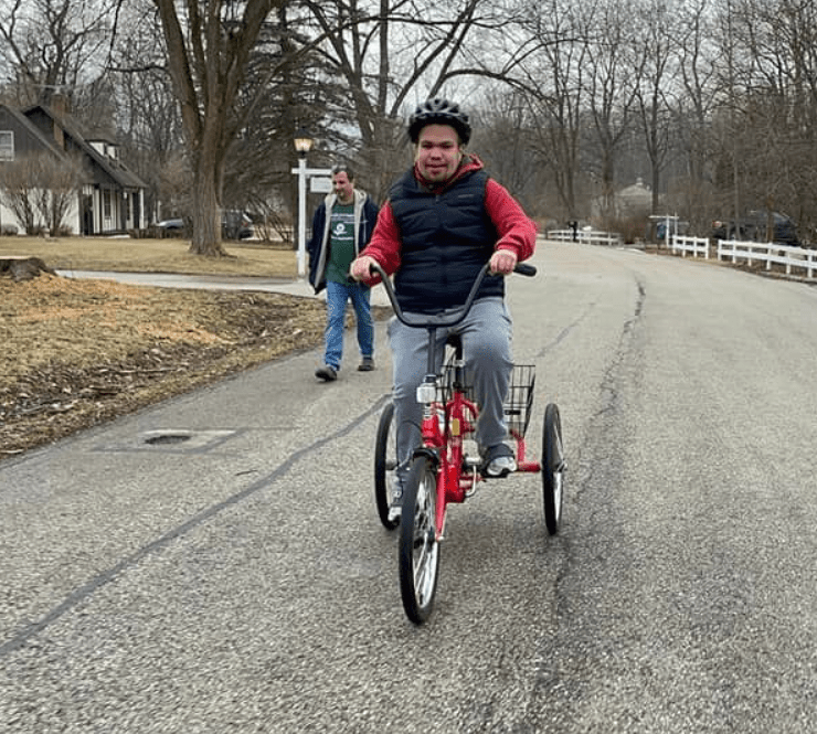 Man with sanfilippo syndrome riding a bicycle