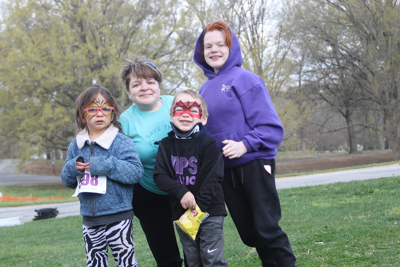 Family of four in a park for the MPS 5k race