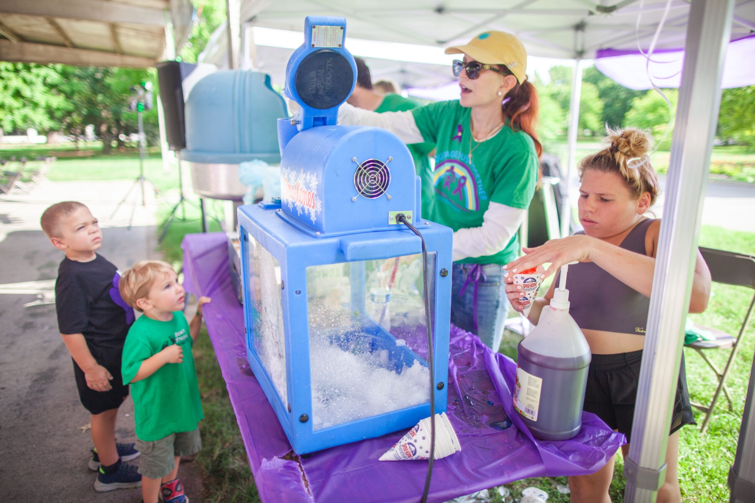 Family operates a snow cone machine at an MPS fundraiser